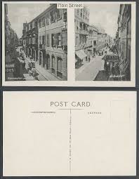 Fantastic range of pipe tobacco, smoking accessories, tobacco pouches, lightetrs, cuban cigars. Gibraltar Old Real Photo Postcard Main Street Scene Royal Tobacconist Bassadone For Sale