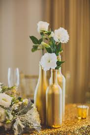It can be very interesting to collect empty wine bottles and make a table centerpiece by yourself. Fleurs Blanches Bouteilles Centres Tables In 2020 Wine Bottle Wedding Centerpieces Wedding Decor Elegant Flower Centerpieces Wedding