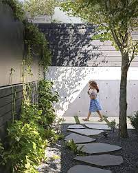Dwell On Instagram A Low Key Landscape Gives A Vancouver Family A New Lease On Outdoor Living With Its Sleek Linear Outdoor Pavers Landscape Garden Fencing