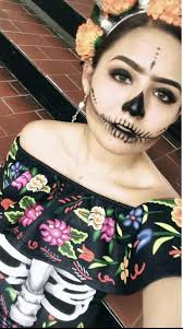 Who offers face painting for Dia de los Muertos in Cozumel?