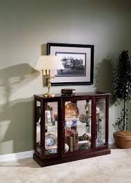 Constructed of solid wood, it boasts a warm brown finish. Curios The Key To Styling And Decorating