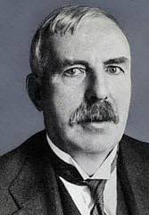 Define the atom according to ERNEST RUTHERFORD?