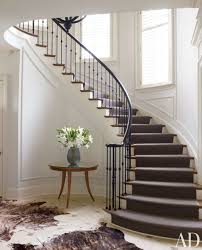 The entry foyer sets the tone for this florida home. To Soften The Formality Of A North Carolina Entrance Hall Designer Russell Groves Simplified The Balusters And Stairs Design Staircase Design Types Of Stairs