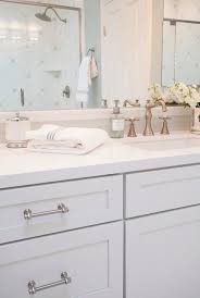 Sticking with a traditional color palette doesn't need to be bland and boring. White Shaker Vanity Cabinets With Gray Glass Tile Backsplash Transitional Bathroom