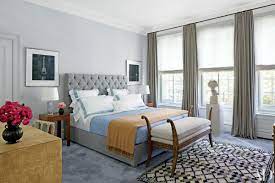 The room offers a large bed and its own living space lighted by a couple of floor lamps. How To Decorate With Layered Rugs And Carpets Architectural Digest