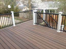 The deck color trends for blue homes all tend to favor the modern and the bold. Trex Spiced Rum Decking With White Post Sleeves And Black Aluminum Rails Look At The Great Color Variation In The Tro House Deck Deck Colors Building A Deck