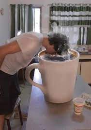 Steaming cup of hot coffee, tea standing near window. Student Loan Help Big Cup Of Coffee Coffee Humor Coffee Obsession