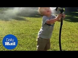 Little Boy Sprays His Face With Water Hose Daily Mail Youtube