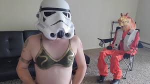 Jar Jar Binks sits in the Cuck Stool while Trans Stormtrooper enjoyments  herself