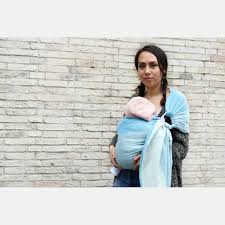 If you're going to hold your baby on your right side, you will put the rings onto your left shoulder. Yaro Newborn Blue Ring Sling