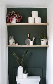 A wood accent wall can add instant character to a room. Give Your Bathroom A Mini Makeover With An Accent Wall And Some Easy Diy Shelves Smallbathroom Acce Bathroom Accent Wall Green Accent Wall Toilet Room Decor