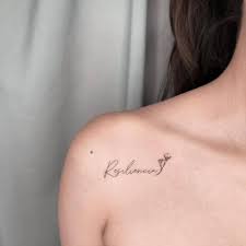Resiliencia And Calla Lilly Tattoo On The Shoulder