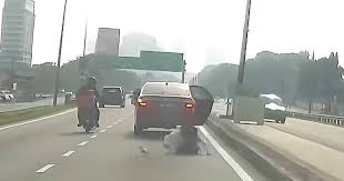 Malaysia woman jumps out of moving car after driver allegedly watches her through rearview mirror