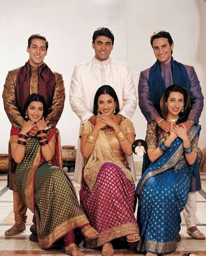 This image shows famous actors Salman Khan, Mohnish Bahl, Saif Ali Khan,  Tabu, and Karisma Kapoor, Sonali Bendre from the iconic 1999 Bollywood  family drama Hum Saath-Saath Hain. The movie was directed
