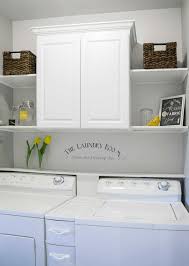 Lift the cabinets onto the ledger board and check for plumb and level. Laundry Room Makeover Installing Cabinets And Shelves How To Craving Some Creativity