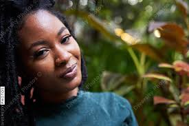 Portrait of young Black woman in garden, plants and nature