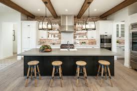 That black countertop is oversized, which is it features a large white kitchen island with a waterfall edge. 29 Ideas For The Perfect Kitchen Island With Seating Build Beautiful
