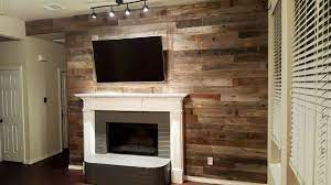 Repurposed wood beams can turn your fireplace into an impressive focal point in your room. Adding Wood To Wall That Has Fireplace Adding A Reclaimed Wood Wall Sustainable Lumber Compan Reclaimed Wood Accent Wall Pallet Wall Decor Wood Accent Wall