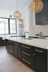 Transitional kitchen with black cabinets & copper vent hood. The Forest Modern Kitchen Q A The House Of Silver Lining