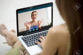 Two Young Women Enjoy Video Call, Communicating Online With App For Virtual  Chat, Girlfriends Talking Online By Laptop Webcam, Calling Friend, Stay In  Touch Despite Long Distance, Close Up Rear View Stock
