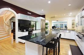 A creative kitchen designed with emerald pearl and white shaker cabinetry. Emerald Pearl Granite Worktops From Mayfair Granite