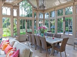 A sunroom is an ideal spot for dining—especially if the room is equipped with a fireplace for winter nights and ceiling fans for summer days. Dining Room Attractice Sunroom Dining Room With Long White Dining Table And Wicker Dining Ch Outdoor Dining Furniture Conservatory Dining Room Sunroom Dining