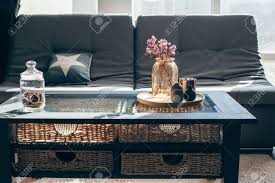 Maybe you would like to learn more about one of these? Home Interior Decor In Gray And Brown Colors Glass Jar With Dried Flowers Vase And Candle On The Wooden Tray On The Coffee Table Over Sofa With Cushions Living Room Decoration Stock