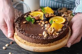 Want unique ideas for birthday desserts that go beyond the usual frosted cake? Hands Decorated With Chocolate Cake Orange And Peanuts And Nuts Concept Healthy Raw Desserts For Vegan Food Stock Photo Image Of Birthday Dessert 147262230