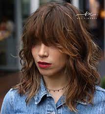 It has a finish that looks flattering on ladies with an oval face shape. 50 Best Styles For Medium Length Hair With Bangs Hair Adviser