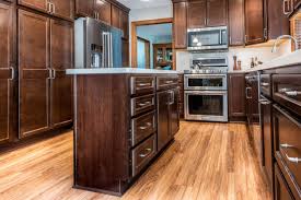 Family members grab a quick breakfast before rushing out the door, kids work on homework and chat about their day while a parent prepares dinner and friends gather around. How To Save Money On The Cost Of Kitchen Remodeling Degnan Design Build Remodel