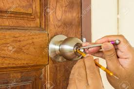 In some cars that have power door locks, the lock/unlock switch actually sends power to the actuators that unlock the door. Locksmith Use Screwdriver Open The Wood Door Can Use To Display Or Montage On Product Stock Photo Picture And Royalty Free Image Image 67432193