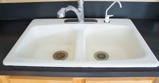 First i covered the whole sink with baking soda and made sure to plug the drain, then i dumped in about a cup of vinegar so everything went crazy sudsy. How To Clean An Enameled Cast Iron Kitchen Sink The Inspired Hive