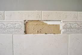 Use a nail or something to break up one tile and pry the bits loose ( after raking the grout out above and below ), then use the chisel to pry the tiles off. Removing An Old Shower Tile Border Young House Love