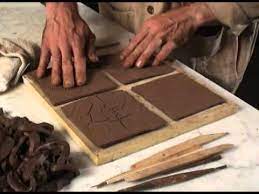 These tiles were cast from the tops of old guardrail posts and arranged into a wall mosaic.learn more about the process: Ceramic Tile Making Youtube