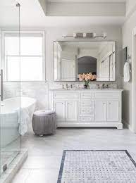Less stark here because there is more white in the tile. Stunning Master Bathroom Featuring A Beveled Beaded Mirror Over A White Dual Washstand Wi White Marble Bathrooms White Marble Countertops Marble Bathroom Floor