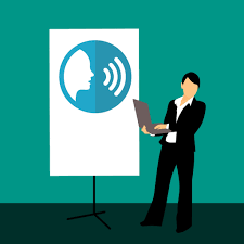 A businessman standing in front of a whiteboard with an image of a man speaking.