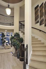 Westin Homes Houston Home Builders Curved Staircase Dark Wood Accents Wood Like Tile Entry New Home Home Decor Westin Homes Home Home Builders