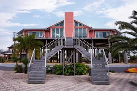 Although, they're not walked any longer, a widow's walk was a railed rooftop addition; Elevated Hurricane Proof Home On Pilings Stilts Beach Style Exterior New Orleans By Topsider Homes Houzz Au