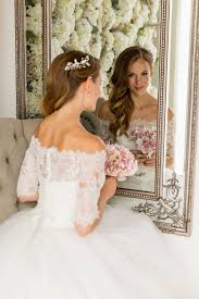 Lace, the traditional wedding dress fabric, has not only maintained but grown its leading position in the modern wedding dresses as the fabric of choice. Bardot Lace Top Wedding Dress Joyce Young
