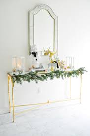Impressive Christmas Entryway Decoration Ideas For 2020 Console tables, foyers, rugs, marble floors, gallery wall, home decor ideas, table styling, home decor, home inspo, gold mirrors, gold decor.
