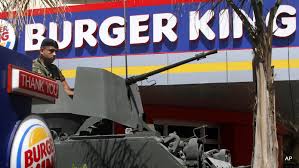Image result for A Lebanese army soldier sits on his armored personnel carrier, as he stands guard outside the Burger King PHOTO