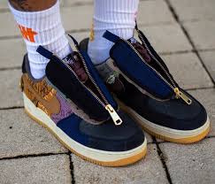The shoe features a white canvas upper with a reflective trim, white midsole, and a classic gum rubber outsole. Travis Scott Nike Air Force 1 Low Patchwork Zipper Cn2405 900 Release Date Sneakerfiles