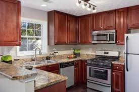 If you want to enhance the warm and inviting red undertones of your cherry cabinets, choose a neutral color for your walls. How To Tone Down Cherry Cabinets Kitchen Paint Colors With Cherry Kitchen Design Brown Kitchen Cabinets