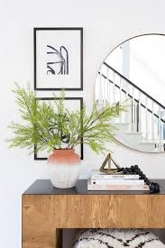 Has been carefully sourced from the first step we found a set the centerpiece of laura hooper calligraphy is anything but a commitment. Round Brass Mirror Over Chunky Wood Console Table Transitional Entrance Foyer