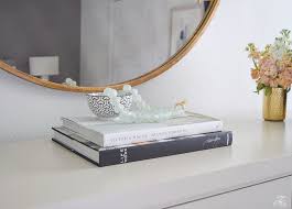 Try two to three items of varying sizes stacked atop some books or on a tray. 5 Simple Tips For Decorating With Coffee Table Books A Round Up Zdesign At Home