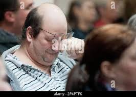 Bruce Buchanan, of Belton, Ky., is overcome with emotion during a candle  light service held for the Watson family at Calvary Baptist Church, Friday,  Jan. 31, 2014, in Central City, Ky. Nine