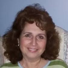 What is the vintage Christmas figurine supposed to be holding?