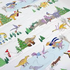 This scary cool gift wrap features a yellow background, green tyrannosaurus, orange deinocheirus, red triceratops, blue pterodactyl, dinosaur foot prints, and green and blue block lettering. Christmas Winter Scene Dinosaur Wrapping Paper By Dinosaurs Doing Stuff Notonthehighstreet Com
