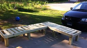 Two posts in the ground with a couple of wooden runners make a simple bench. How To Build A Bench With These Free Diy Woodworking Plans