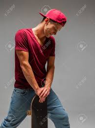 Download, share or upload your own one! Cool Guy Skateboarder In Baseball Cap Stands With Skateboard In Studio On Grey Background Photo About Skateboarding Stock Photo Picture And Royalty Free Image Image 153381858